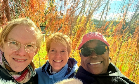 A photo of Emma Dryden, Eileen Robinson, and Harold Underdown, out together in  the sunshine